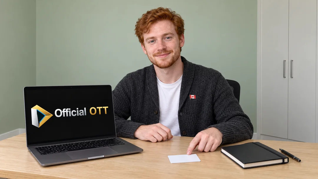 A young man pointing to a blank card beside a laptop